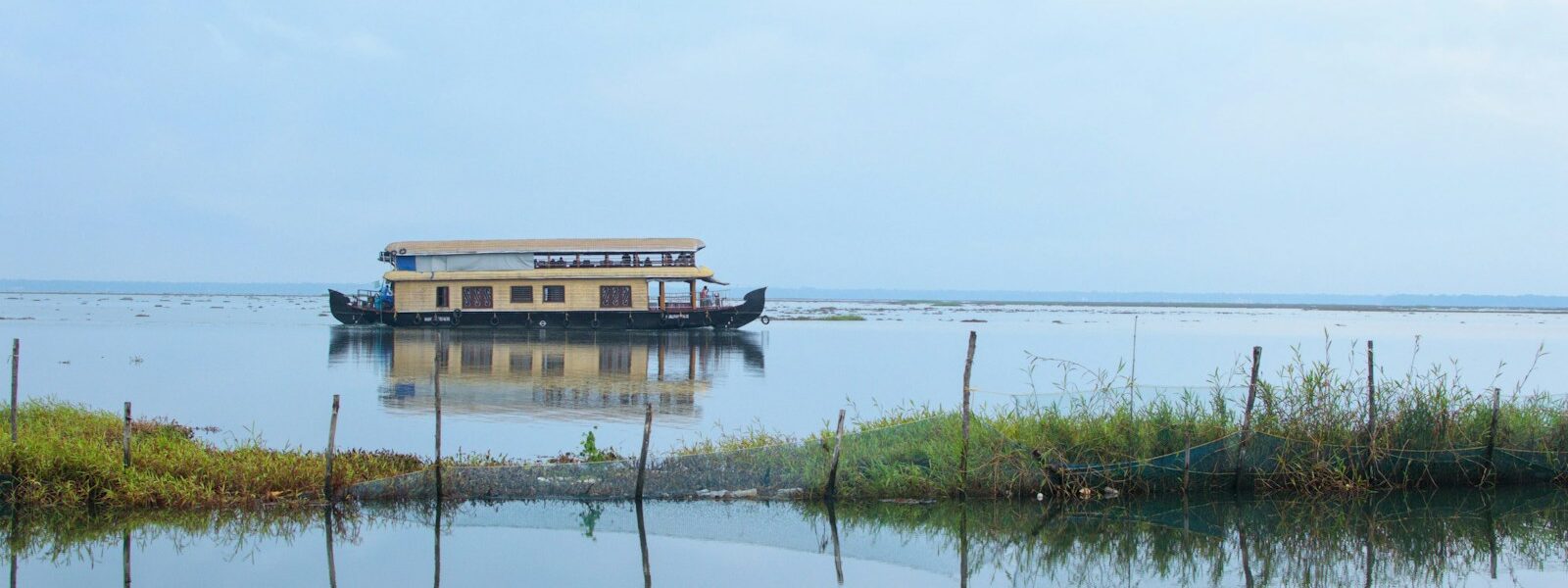 a house boat floating on top of a lake